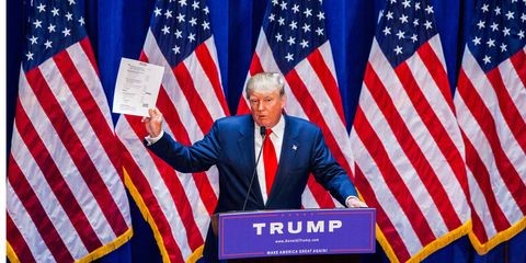 Trump holds up document
Trump holds up paper