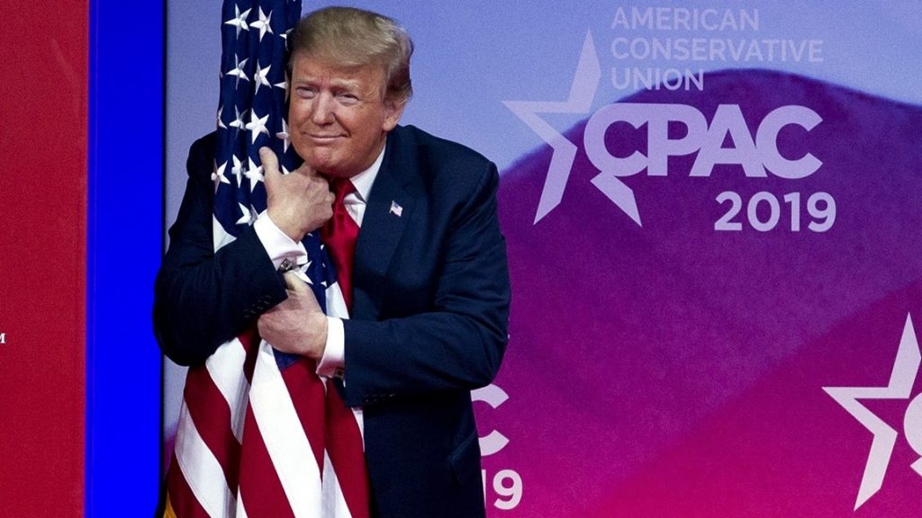 Trump hugs flag